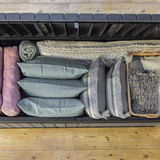 Large storage box filled with cushions and blankets