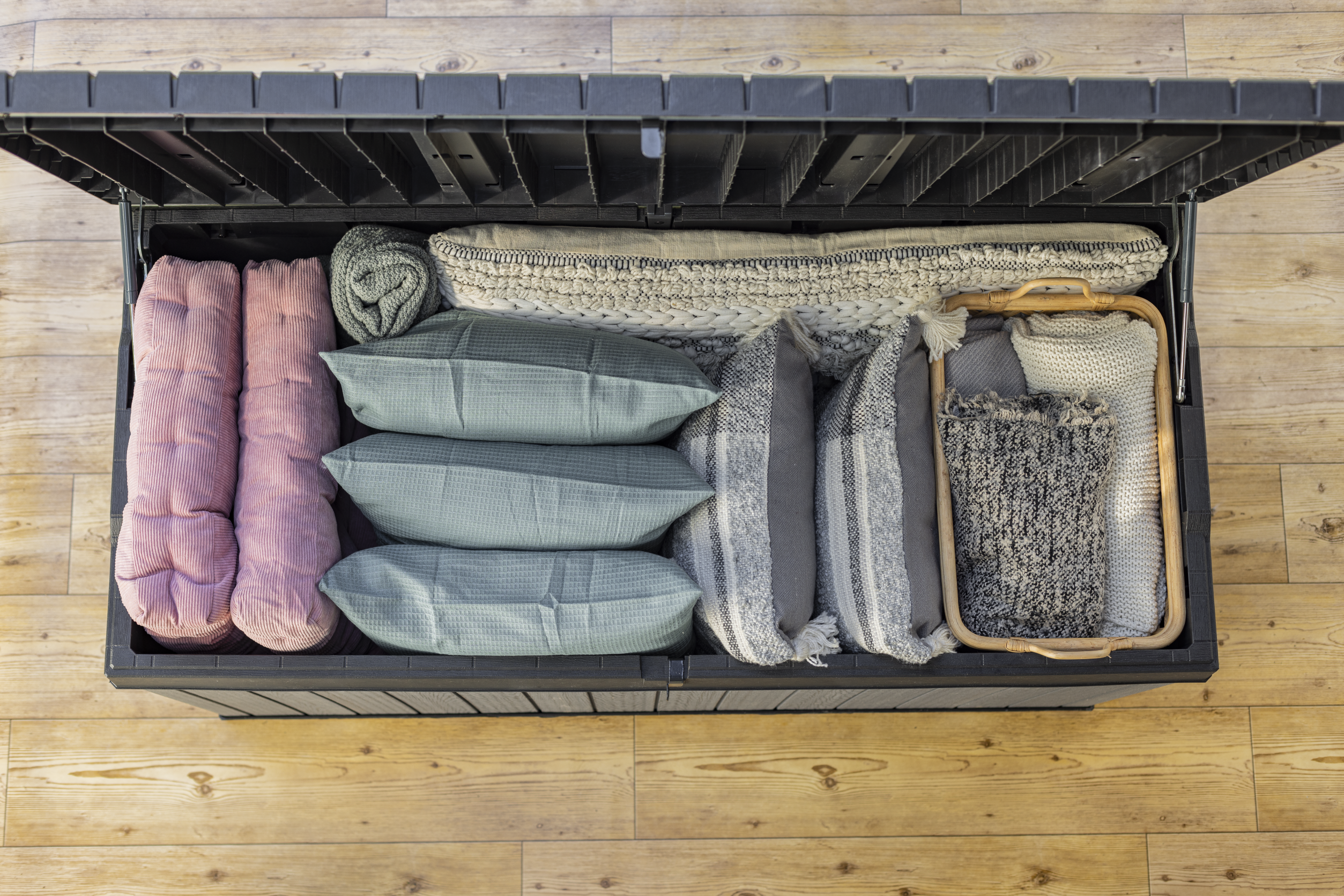 Large storage box filled with cushions and blankets