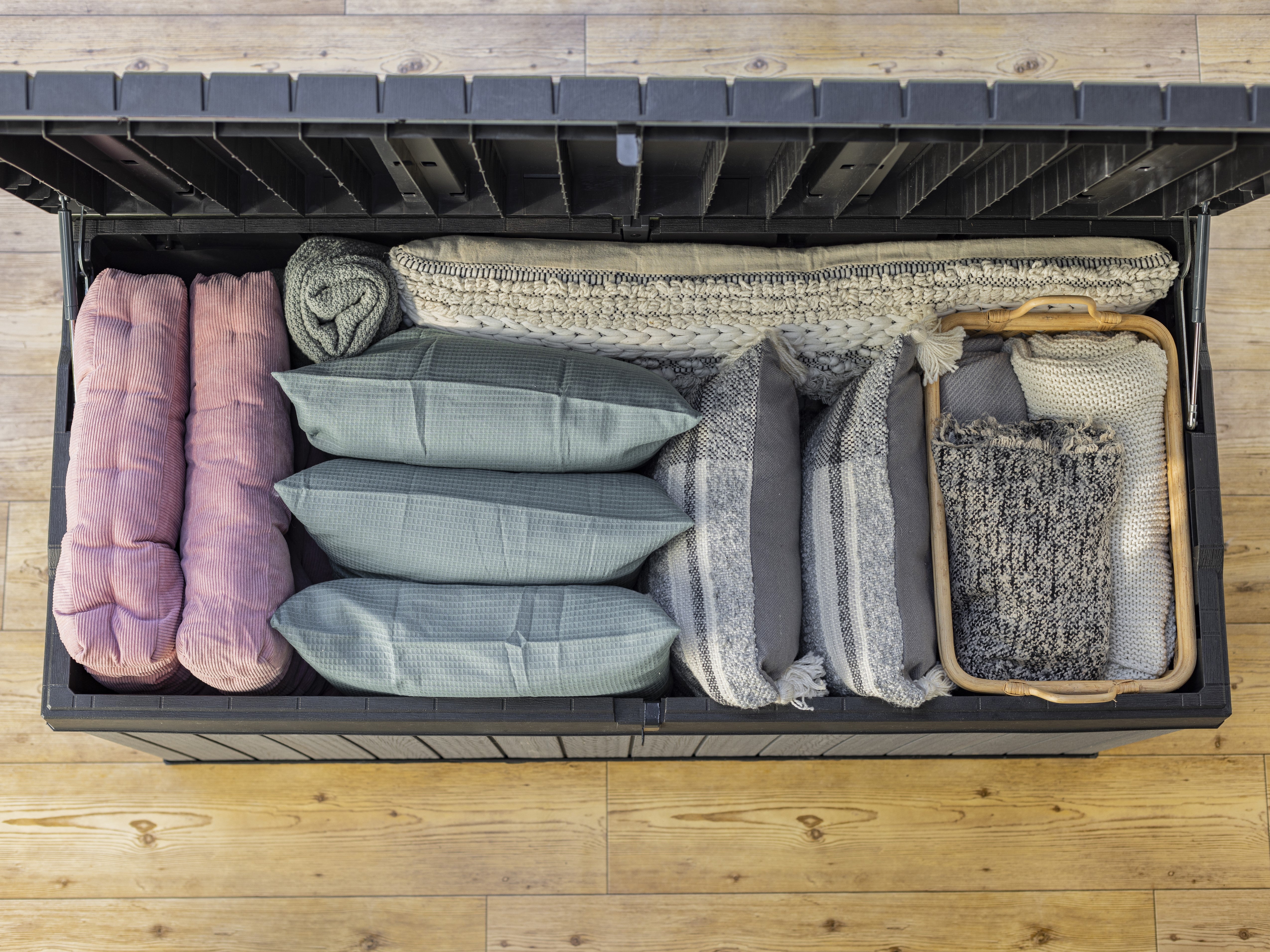 Storage box filled with cushions and blankets