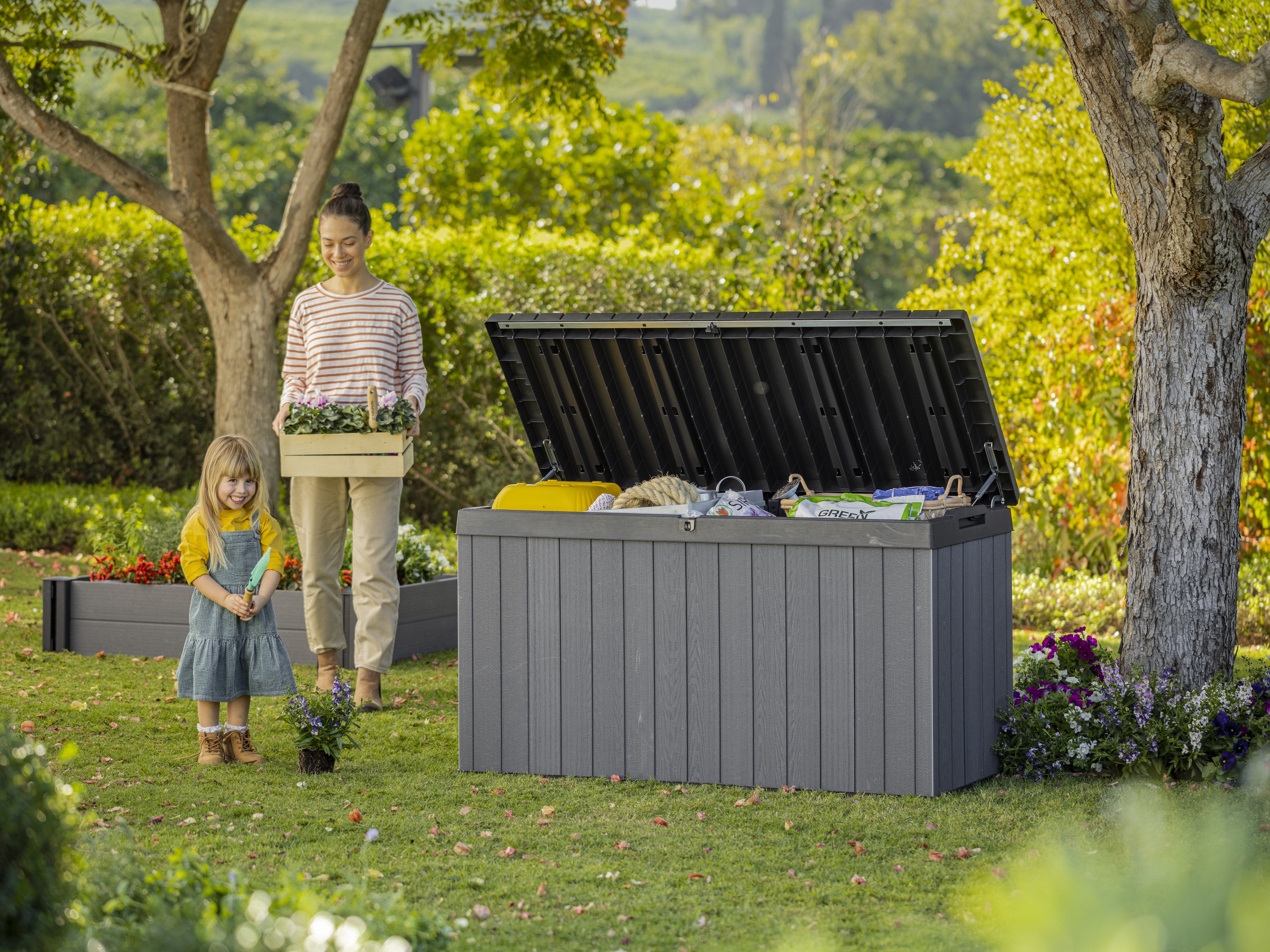 Large storage box filled with gardening items