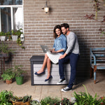 A couple sitting on the lid of the Denali cushion box