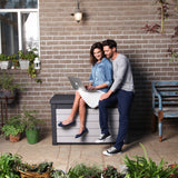 A couple sitting on the lid of the Denali cushion box