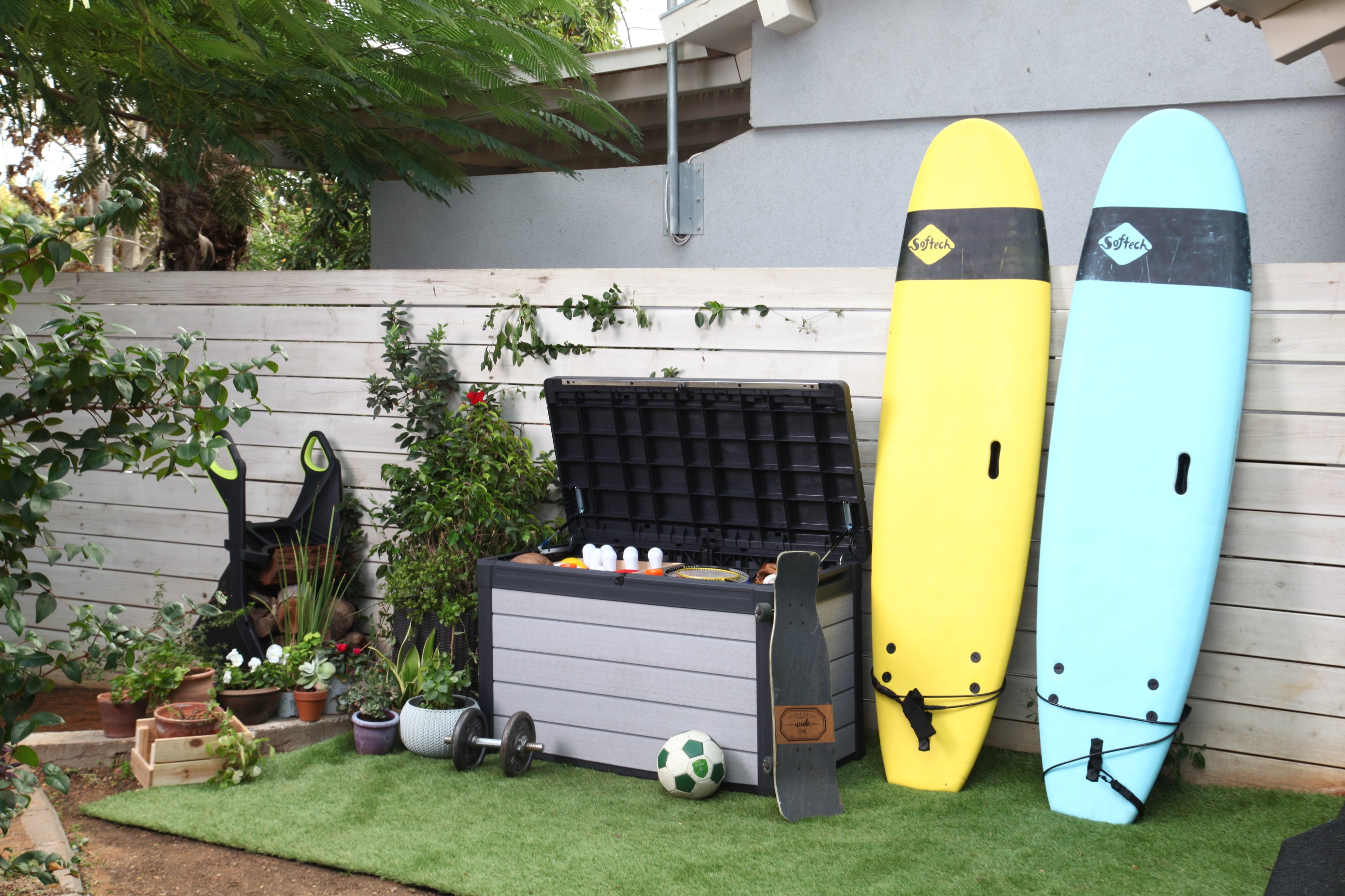 Cushion box in patio setting with surfboards and sports equipment