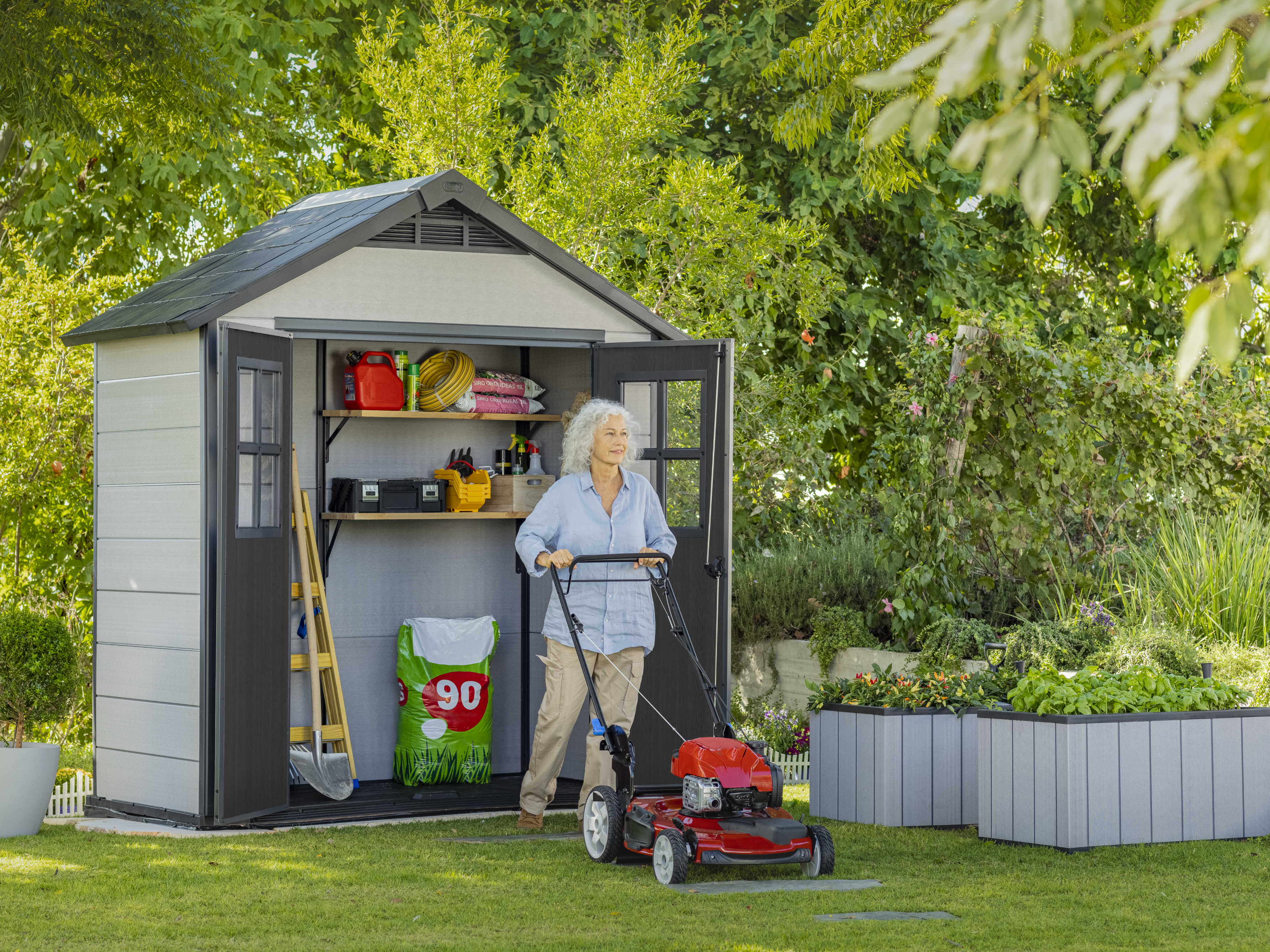 Keter Oakland 754 with woman mowing the lawns