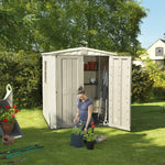 A woman potting plants in front of the factor 6x6 Shed