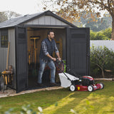 Keter Oakland 759 shed with man mowing  lawns