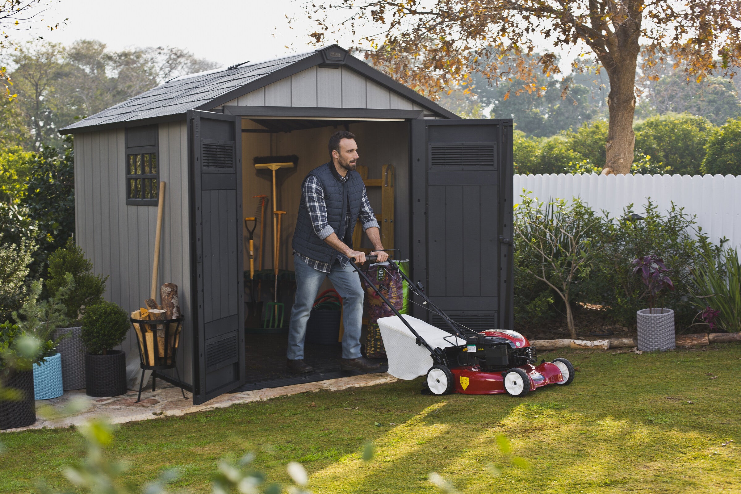 Keter Oakland 759 shed with man mowing  lawns