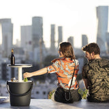 A couple enjoying the Go Bar chilly bin with city backdrop